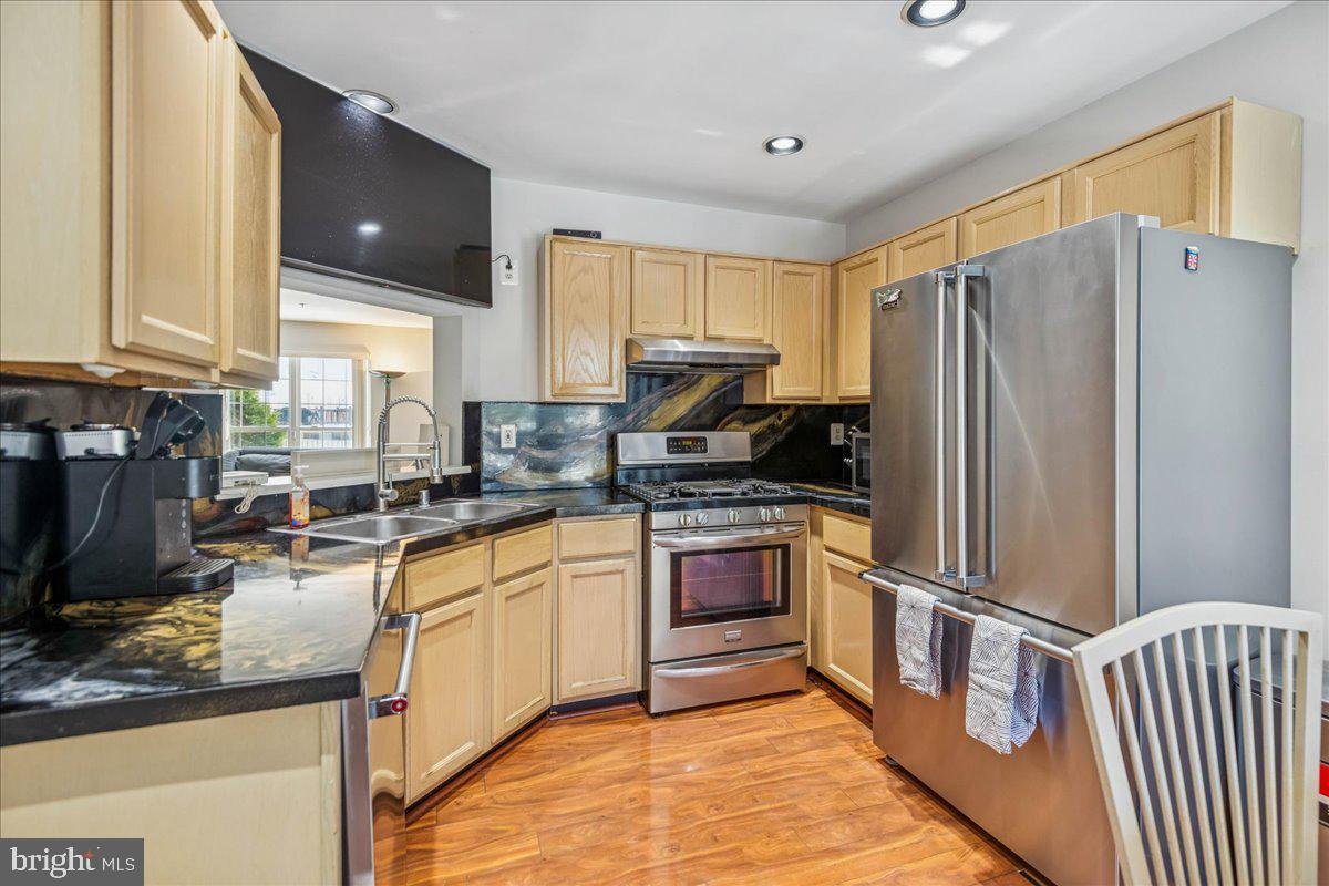 7536 Maury Road Windsor Mill, MD 21244 - Photo 11 of 36 a kitchen with granite countertop stainless steel appliances and wooden cabinets