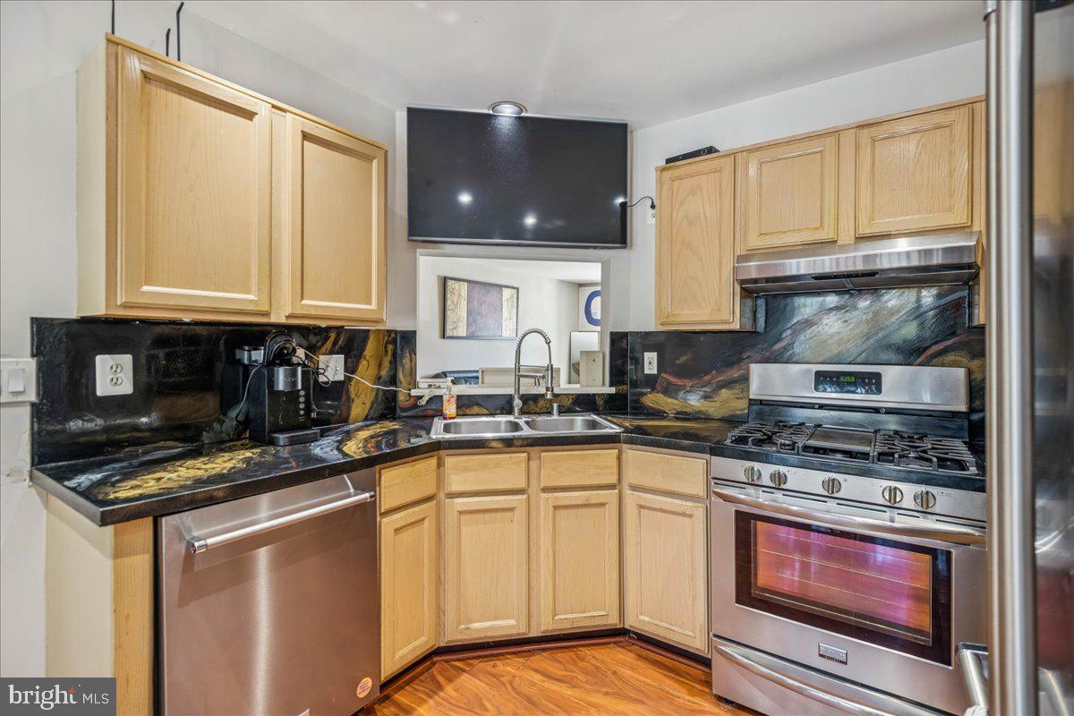 7536 Maury Road Windsor Mill, MD 21244 - Photo 12 of 36 a kitchen with stainless steel appliances granite countertop a stove sink and cabinets