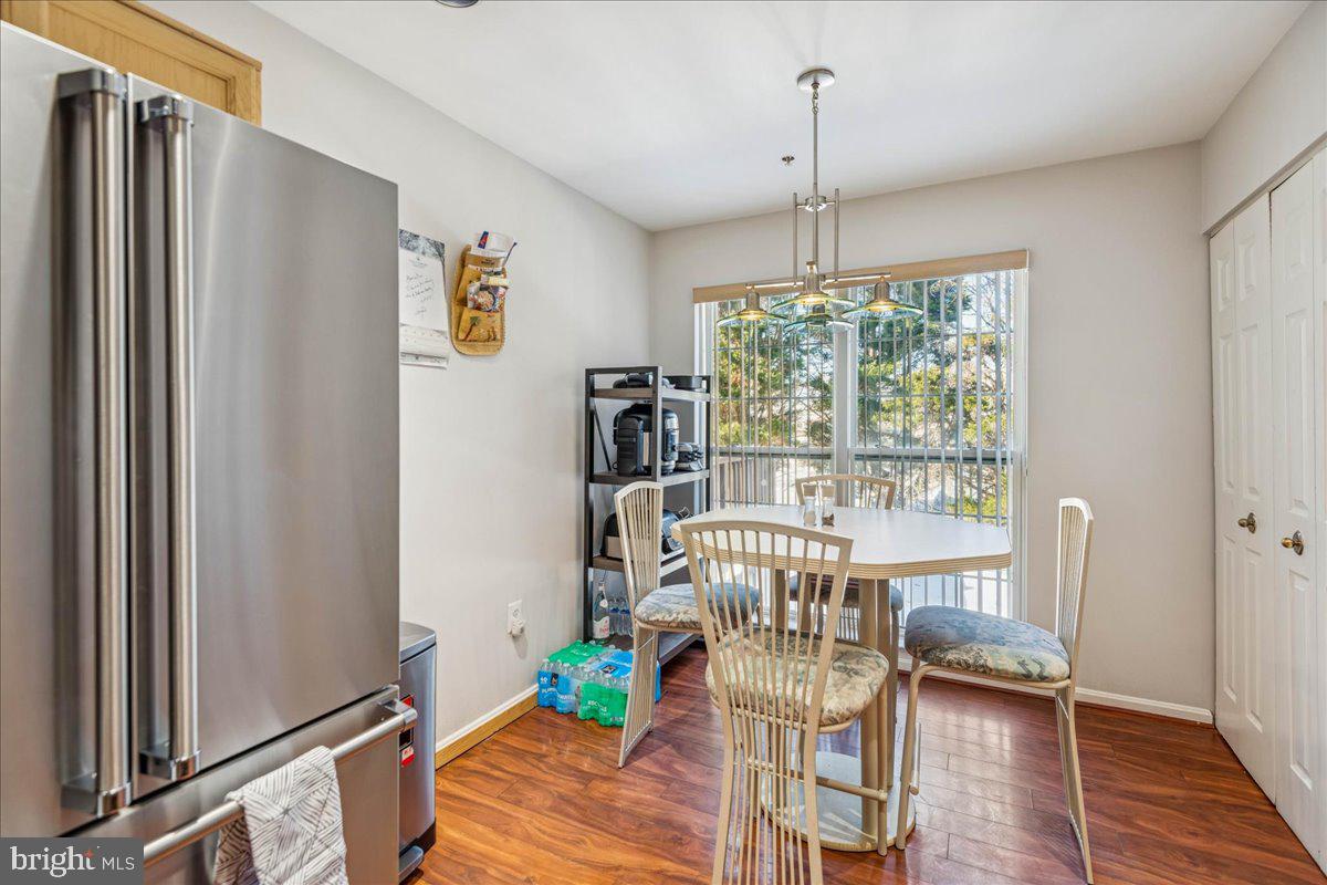 7536 Maury Road Windsor Mill, MD 21244 - Photo 13 of 36 a view of a dining room with furniture window and wooden floor