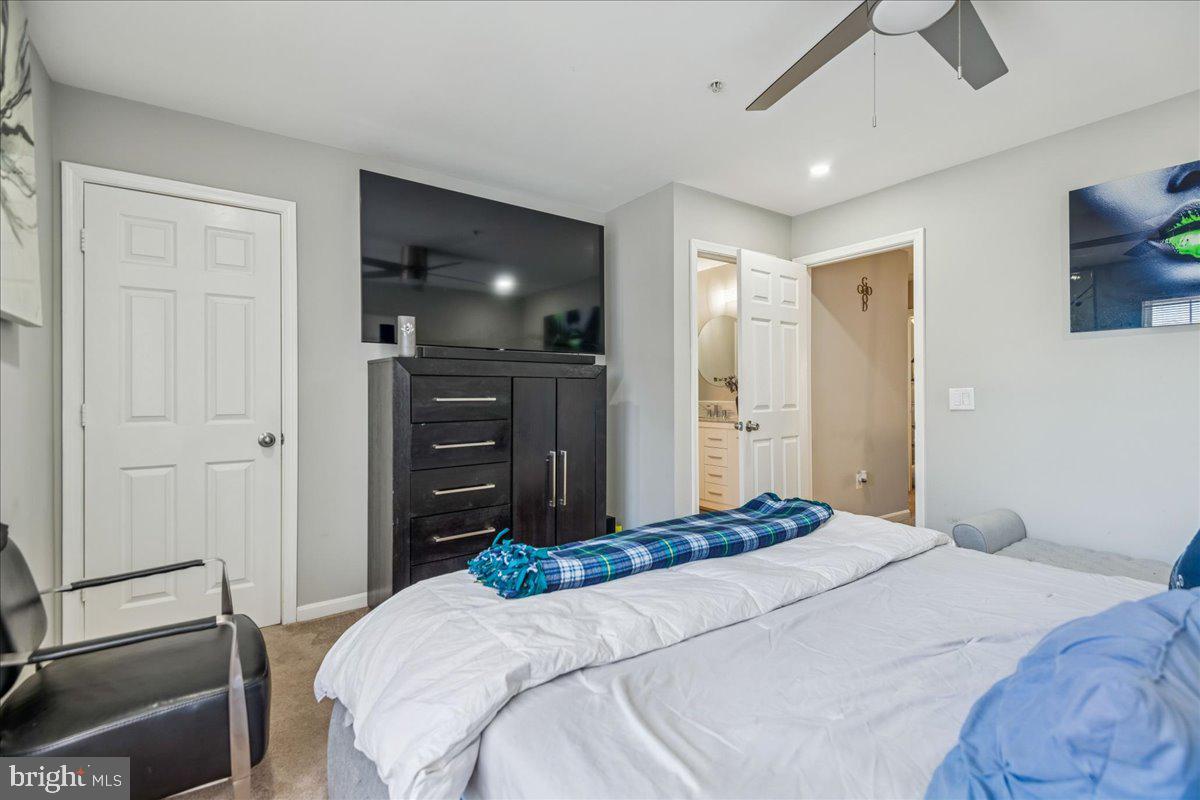 7536 Maury Road Windsor Mill, MD 21244 - Photo 18 of 36 a bedroom with a bed and a flat tv screen