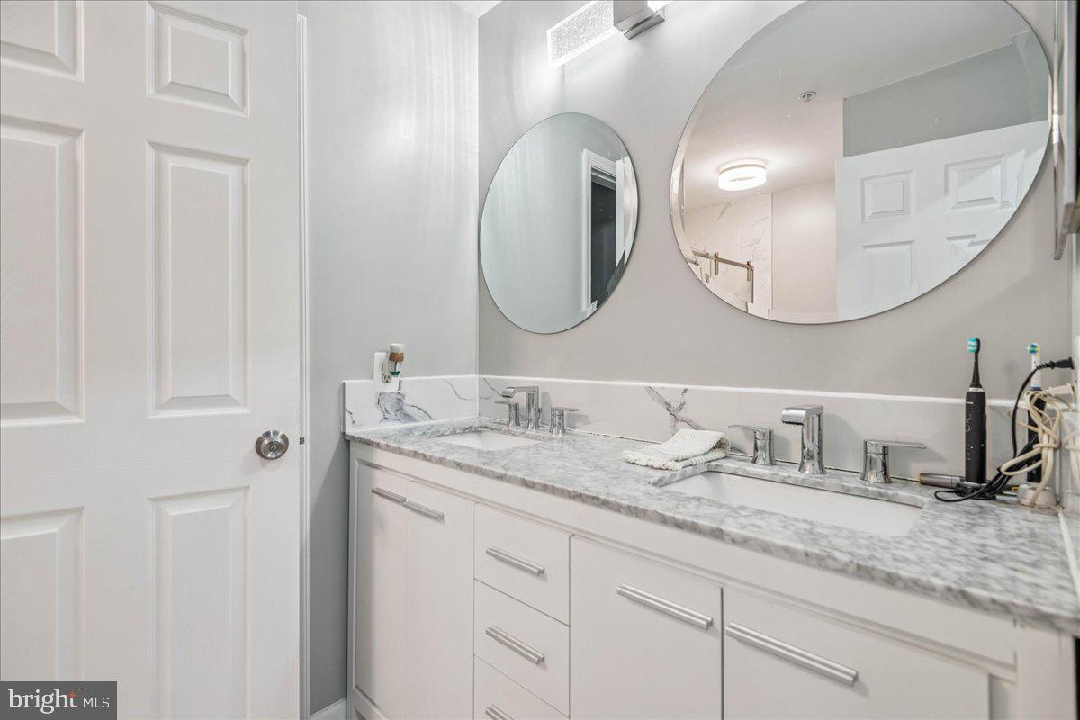 7536 Maury Road Windsor Mill, MD 21244 - Photo 20 of 36 a bathroom with a granite countertop double vanity sinks and a mirror