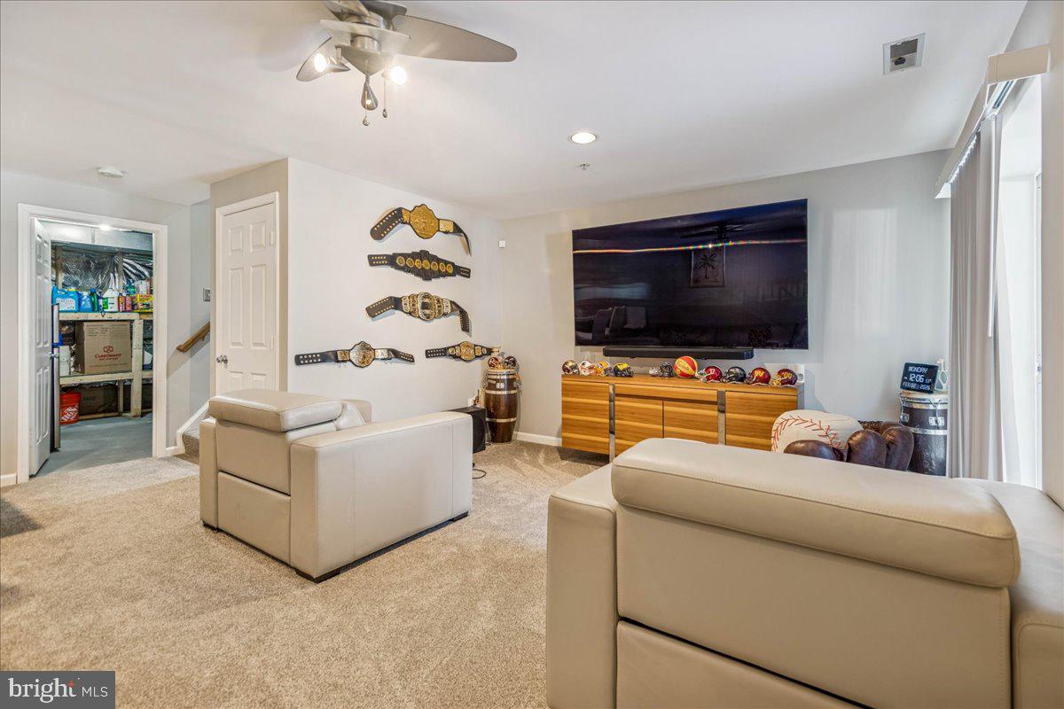 7536 Maury Road Windsor Mill, MD 21244 - Photo 28 of 36 a living room with furniture and a flat screen tv