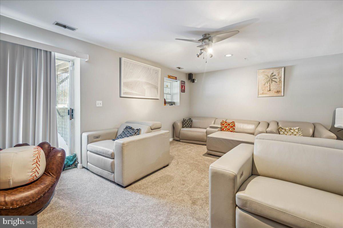 7536 Maury Road Windsor Mill, MD 21244 - Photo 29 of 36 a living room with furniture and a chandelier