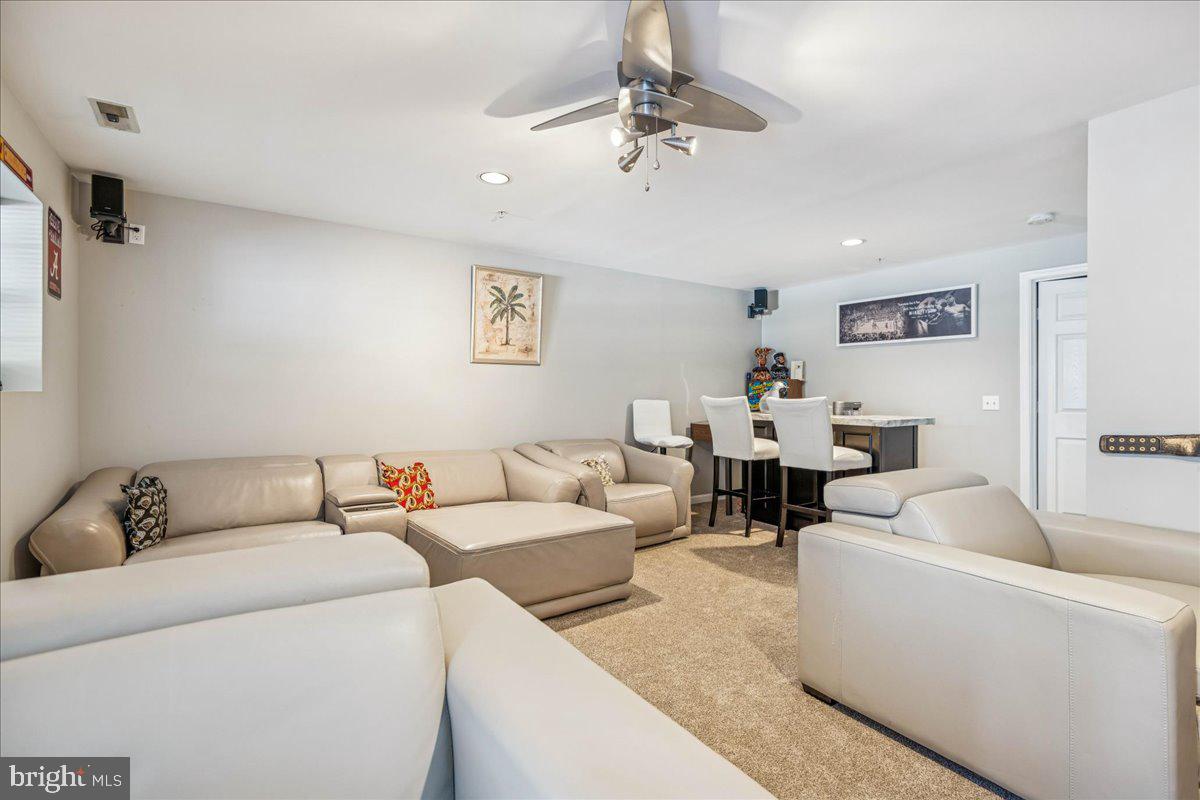 7536 Maury Road Windsor Mill, MD 21244 - Photo 31 of 36 a living room with furniture and a chandelier
