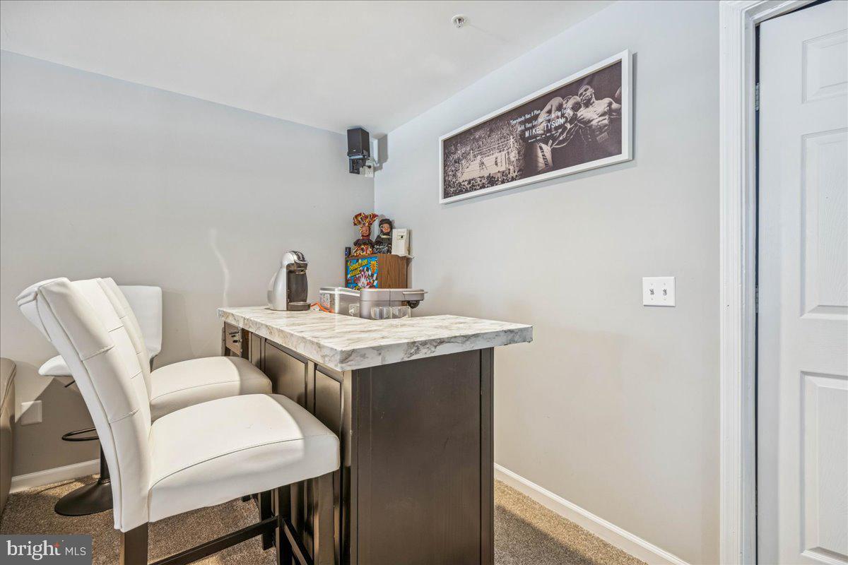 7536 Maury Road Windsor Mill, MD 21244 - Photo 32 of 36 a dining room with a table and chairs