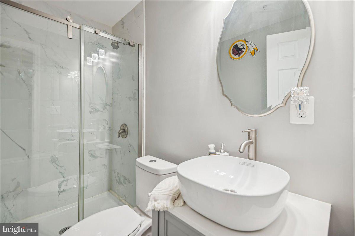 7536 Maury Road Windsor Mill, MD 21244 - Photo 34 of 36 a bathroom with a sink toilet and shower