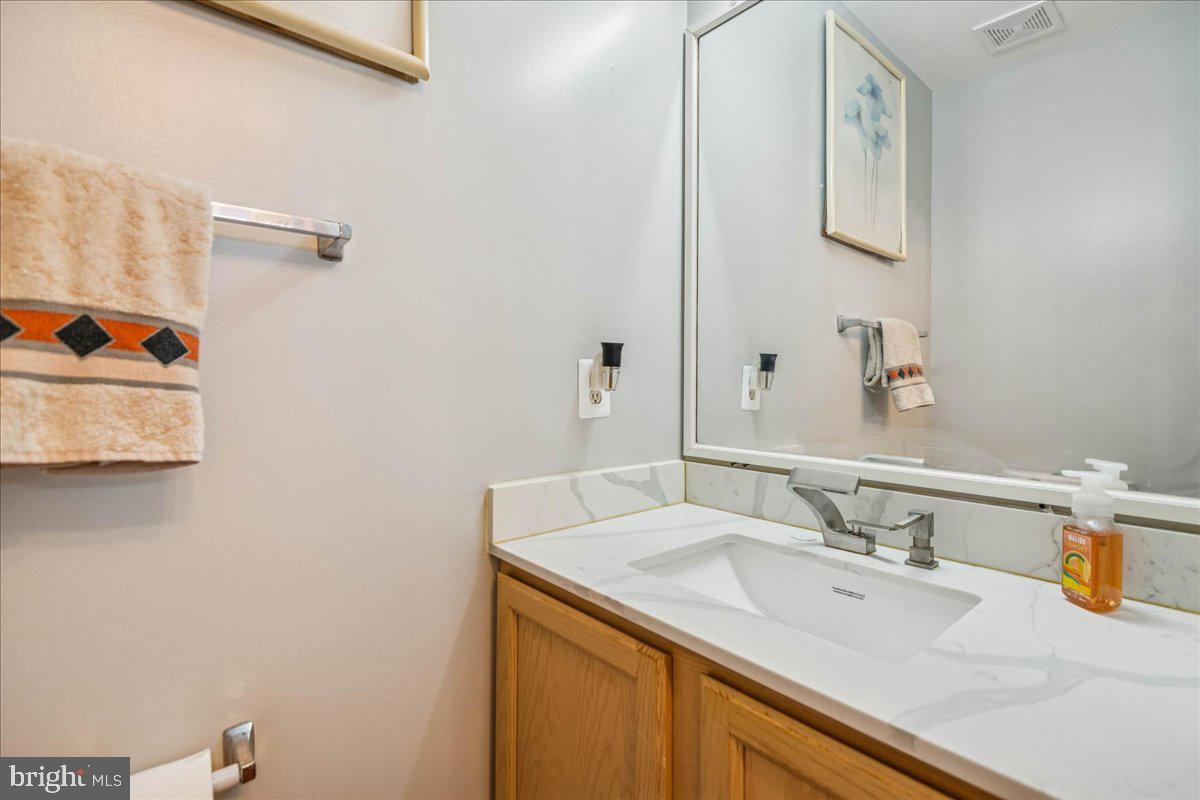 7536 Maury Road Windsor Mill, MD 21244 - Photo 5 of 36 a bathroom with a sink and a mirror