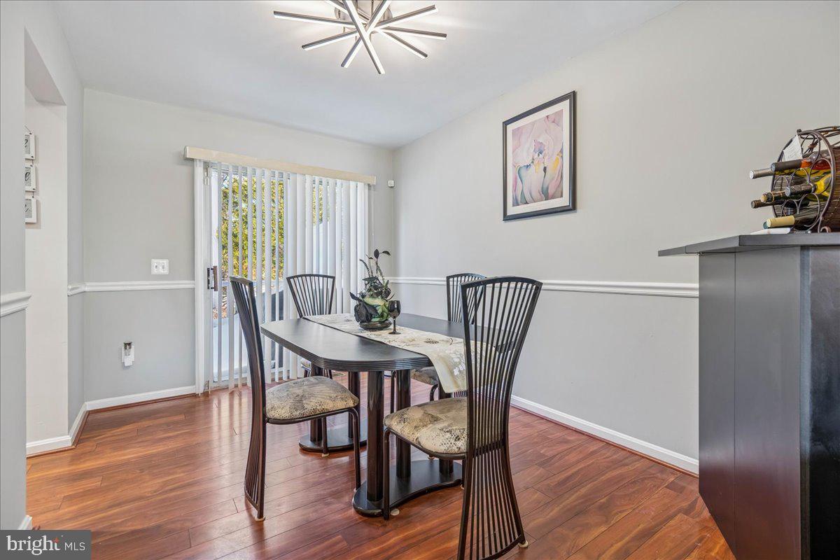 7536 Maury Road Windsor Mill, MD 21244 - Photo 9 of 36 a view of a dining room with furniture window and wooden floor