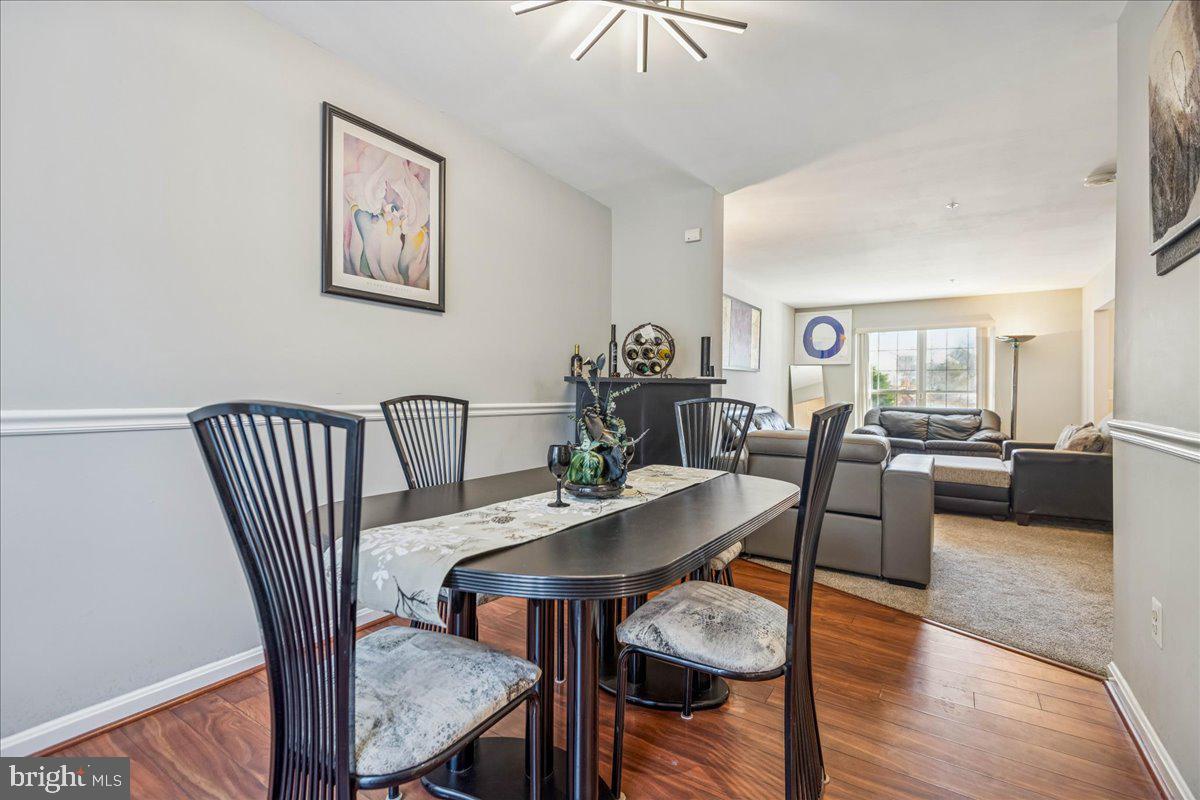 7536 Maury Road Windsor Mill, MD 21244 - Photo 10 of 36 a view of a dining room with furniture and wooden floor