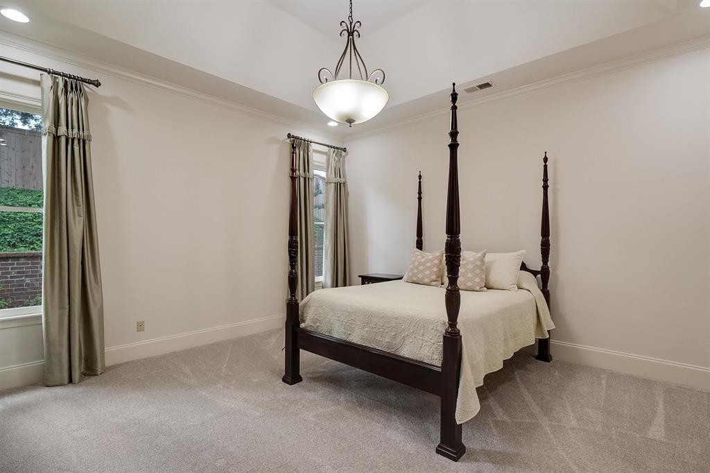 1185 Braystone Trail Collierville, TN 38017 - Photo 14 of 39 a bedroom with a bed lamp and a chandelier