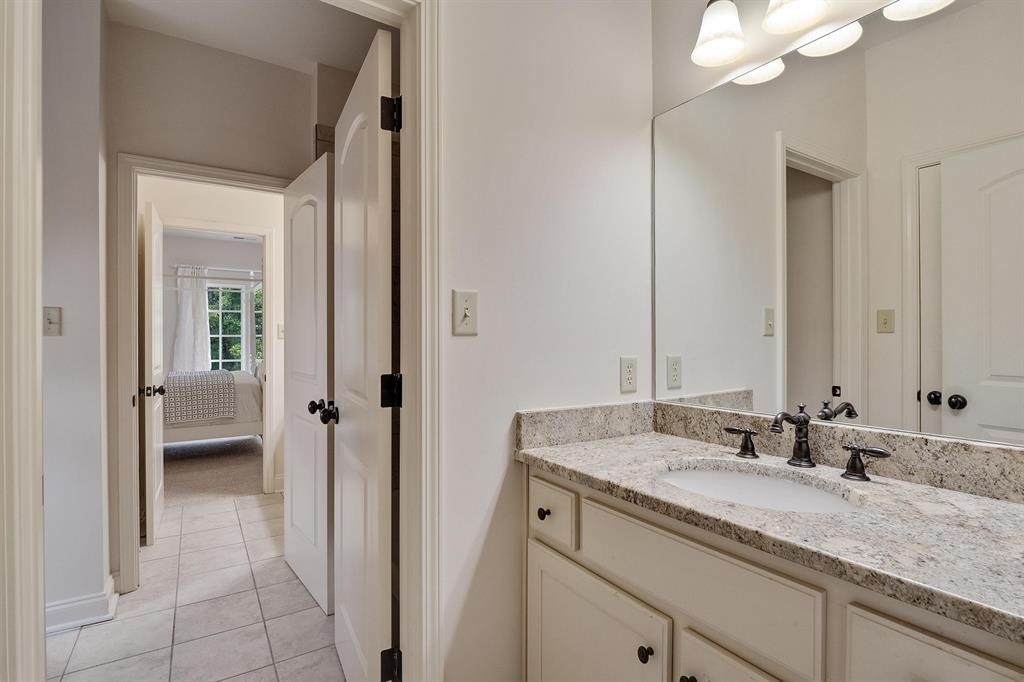 1185 Braystone Trail Collierville, TN 38017 - Photo 20 of 39 a bathroom with a granite countertop sink and a mirror