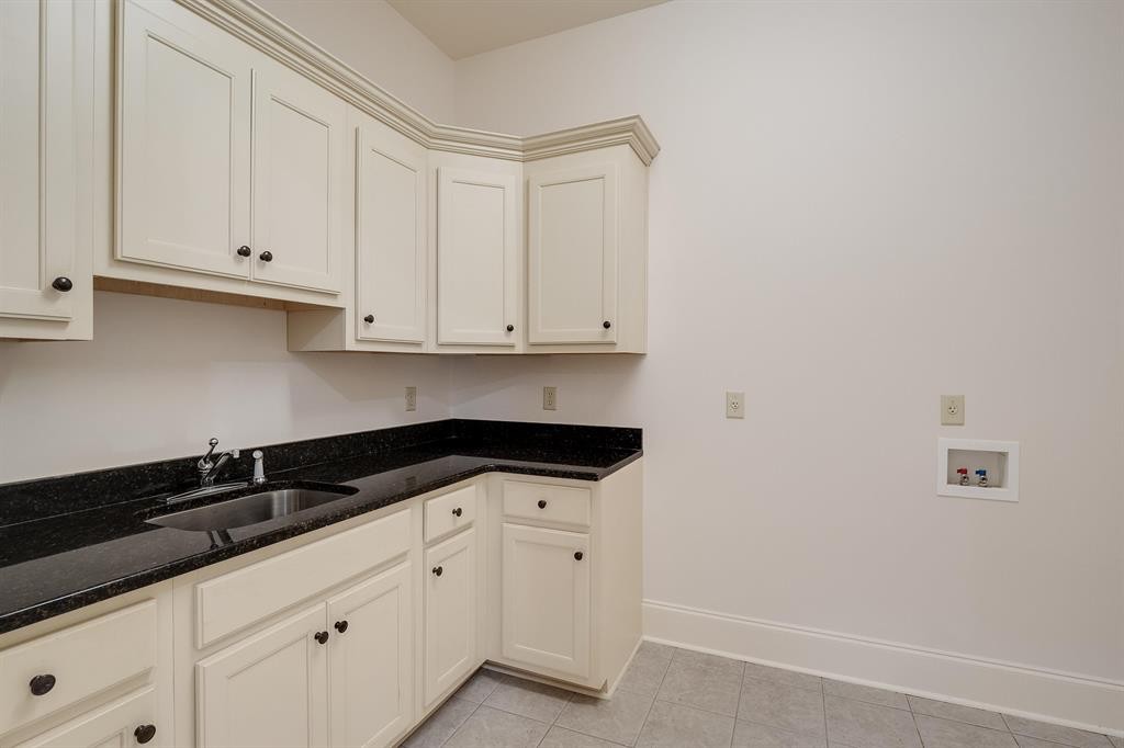 1185 Braystone Trail Collierville, TN 38017 - Photo 28 of 39 a kitchen with granite countertop white cabinets and sink