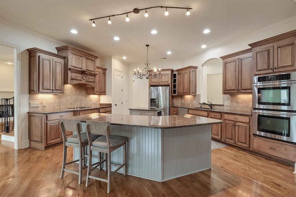 1185 Braystone Trail Collierville, TN 38017 - Photo 4 of 39 a kitchen with kitchen island granite countertop a sink cabinets and stainless steel appliances