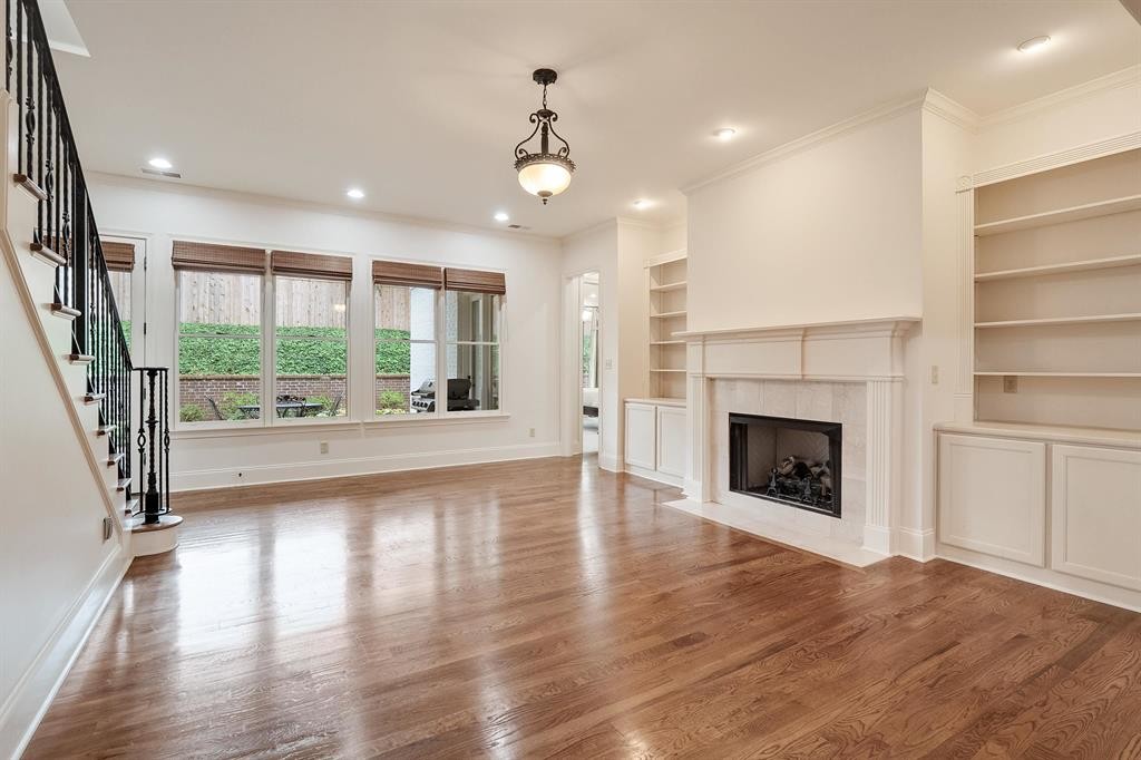 1185 Braystone Trail Collierville, TN 38017 - Photo 9 of 39 an empty room with wooden floor a fireplace and windows