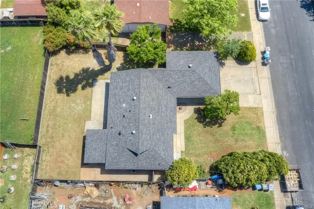 an aerial view of a house with a yard