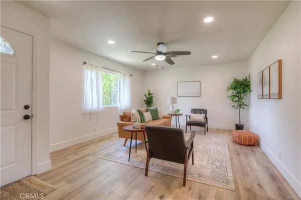 a view of a livingroom with furniture window and wooden floor
