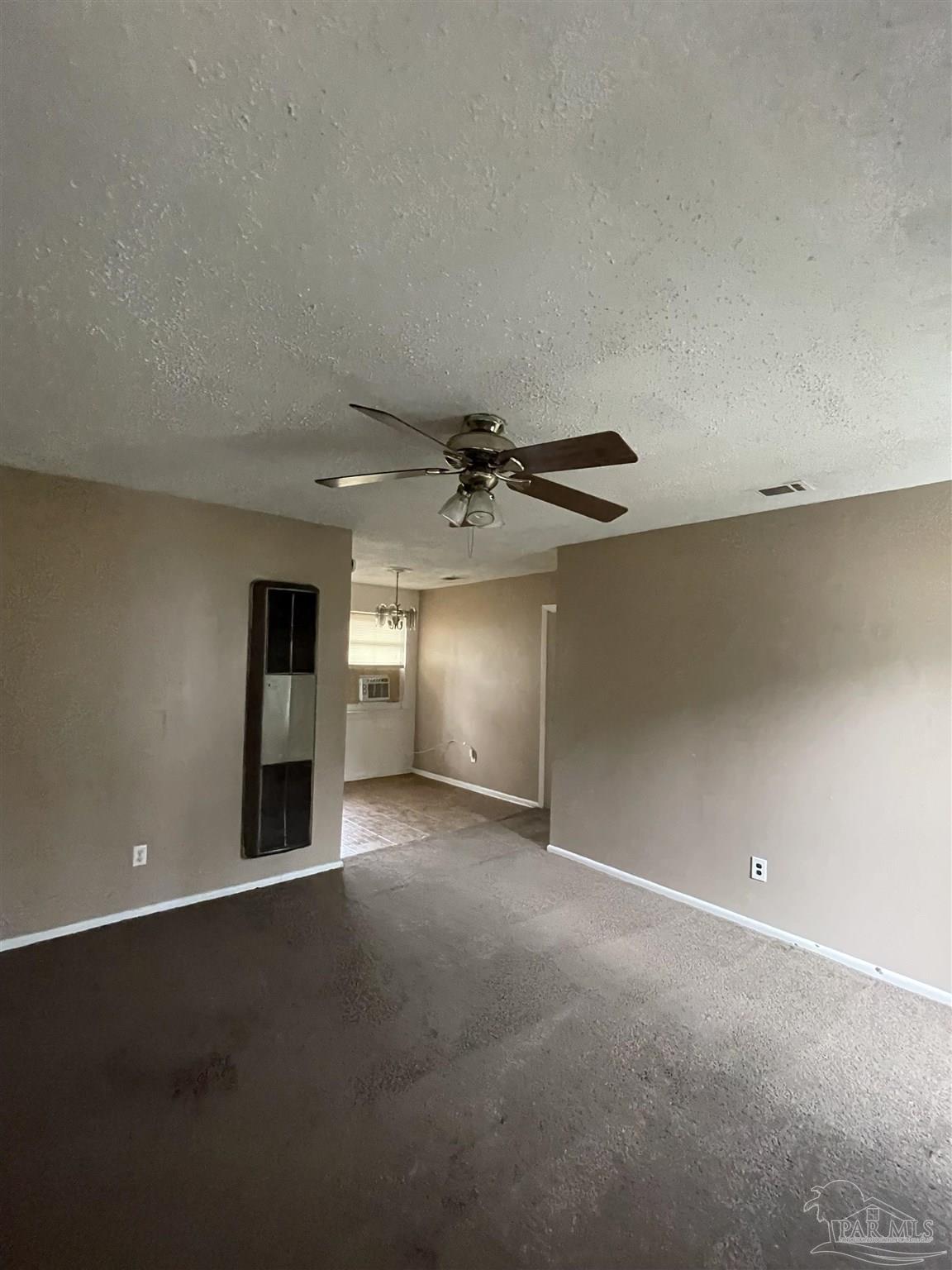 701 East Montclair Road Pensacola, FL 32505 - Photo 6 of 10 an empty room with a empty space and a ceiling fan