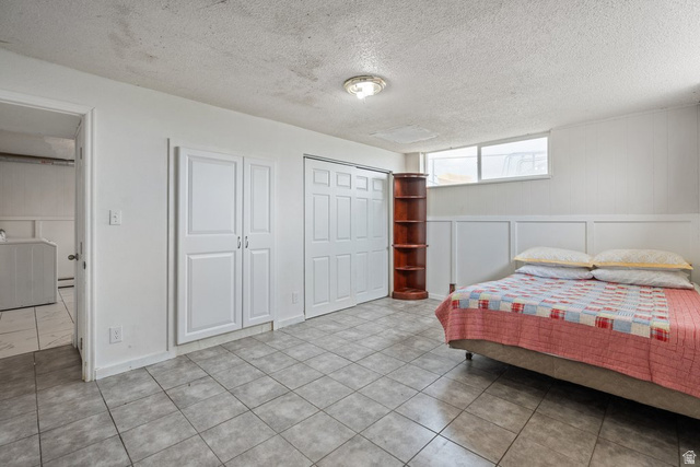 149 West 1600th Street South Mapleton, UT 84664 - Photo 17 of 44 Bedroom featuring a textured ceiling, a decorative wall, washer / dryer, and a closet