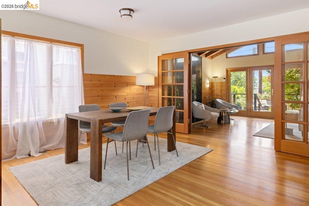 287 Purdue Avenue Kensington, CA 94708 - Photo 17 of 60 Dining area with wood-finish flooring, half-wall wood paneling, and an overhead light fixture