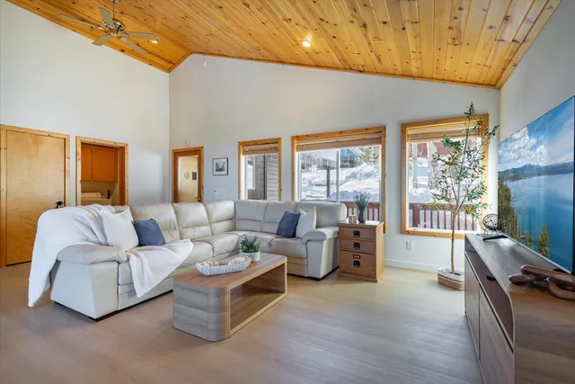 a bedroom with a bed two lamps and a large window