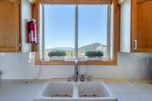 a bed sitting in a spacious bedroom next to a window