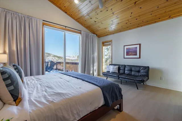 a spacious bedroom with a bed and a couch