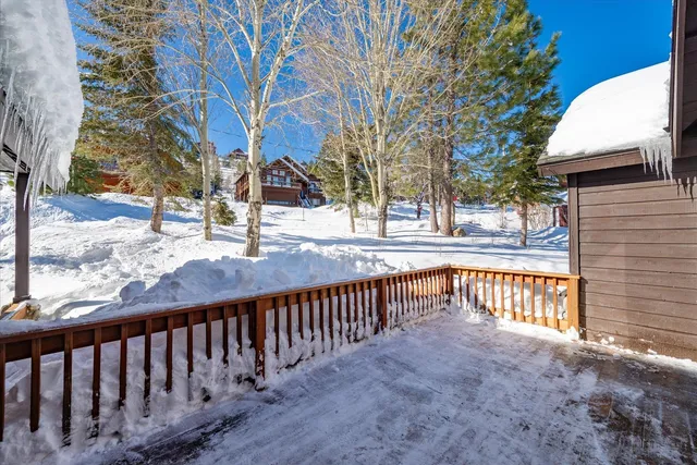 a side view of a house with a bench