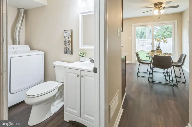 a bathroom with a toilet sink and a mirror