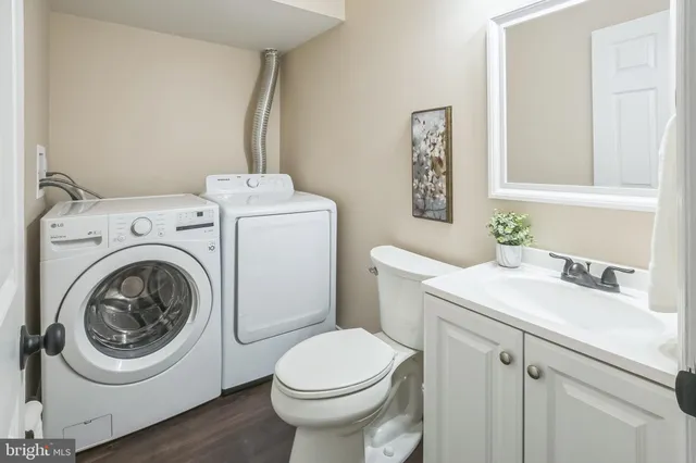a bathroom with a sink a toilet and a mirror