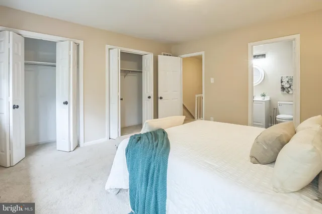 a bedroom with a bed and a mirror