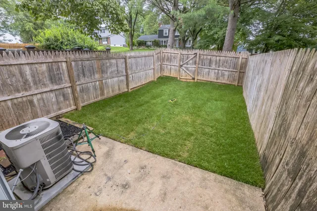 a view of a backyard with wooden fence