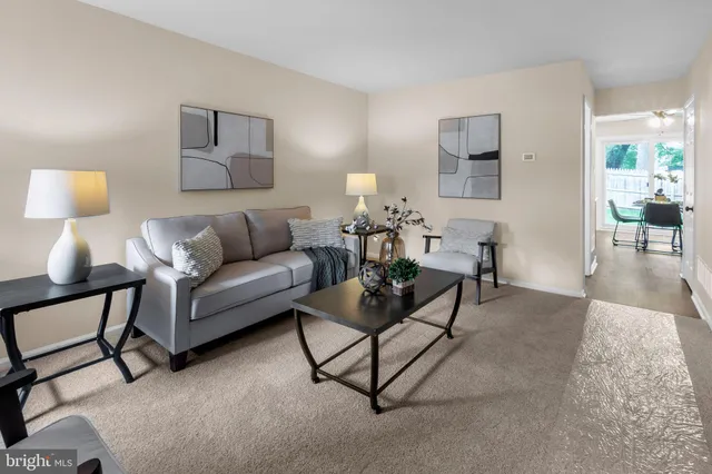 a living room with furniture and a lamp