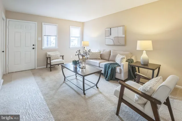 a living room with furniture and a lamp