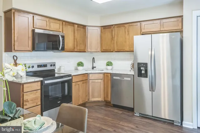 a kitchen with a refrigerator sink and stove