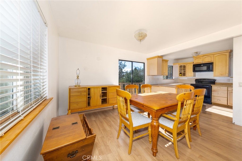 26785 Hopkins Road Idyllwild, CA 92549 - Photo 16 of 46 a dining room with furniture and wooden floor