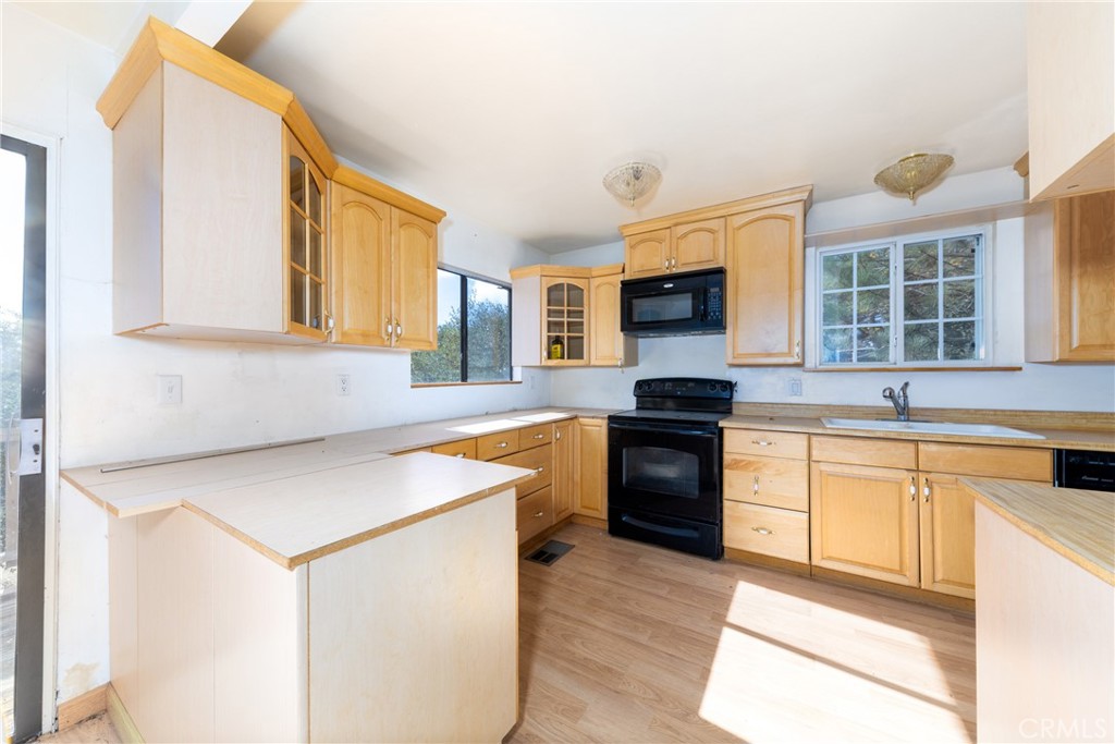 26785 Hopkins Road Idyllwild, CA 92549 - Photo 18 of 46 a kitchen with granite countertop a stove a sink and a microwave