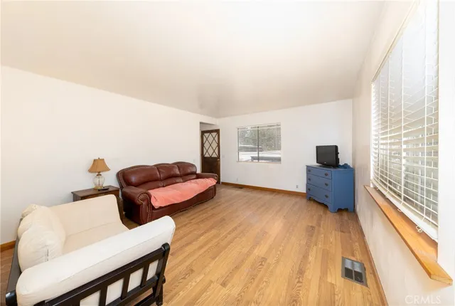 a dining room with furniture and wooden floor