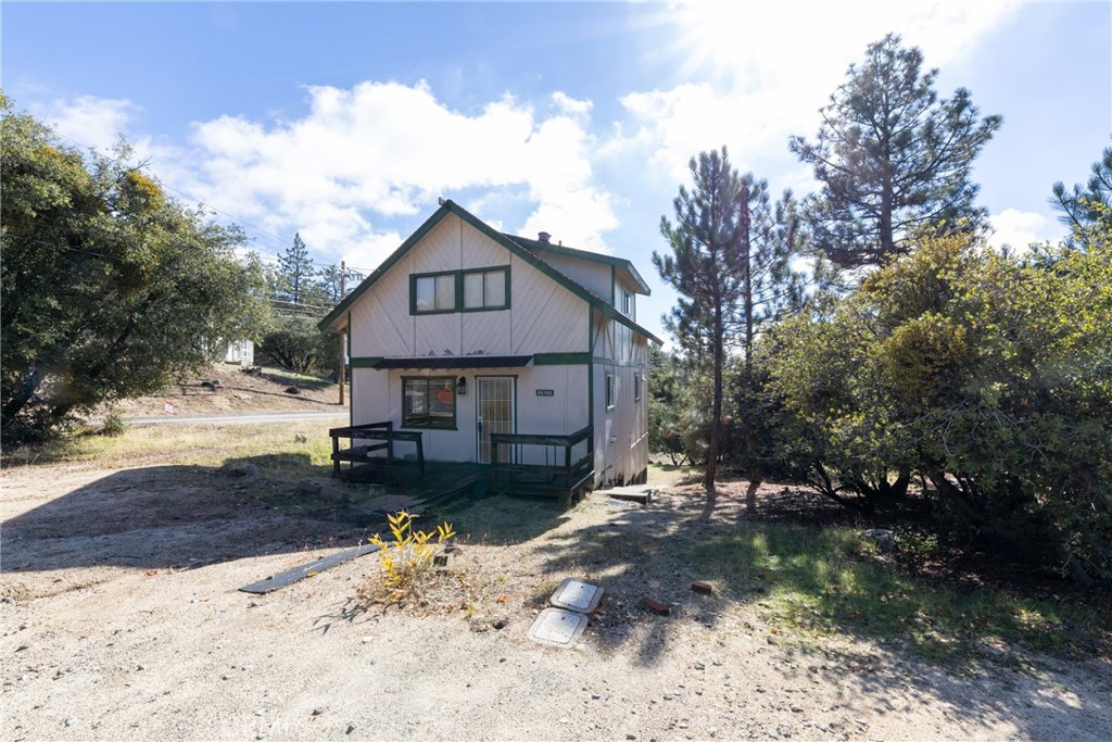 26785 Hopkins Road Idyllwild, CA 92549 - Photo 2 of 46 a view of a house with a yard covered in snow