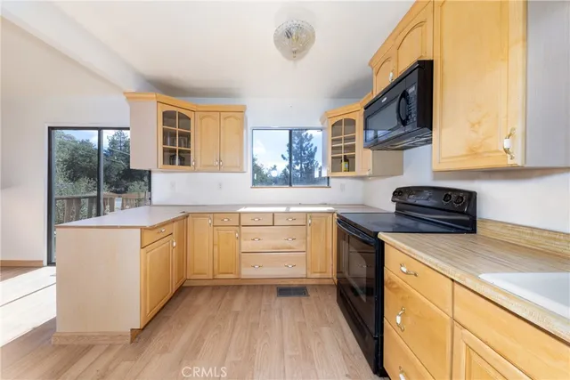 a kitchen with stainless steel appliances granite countertop a stove and a microwave