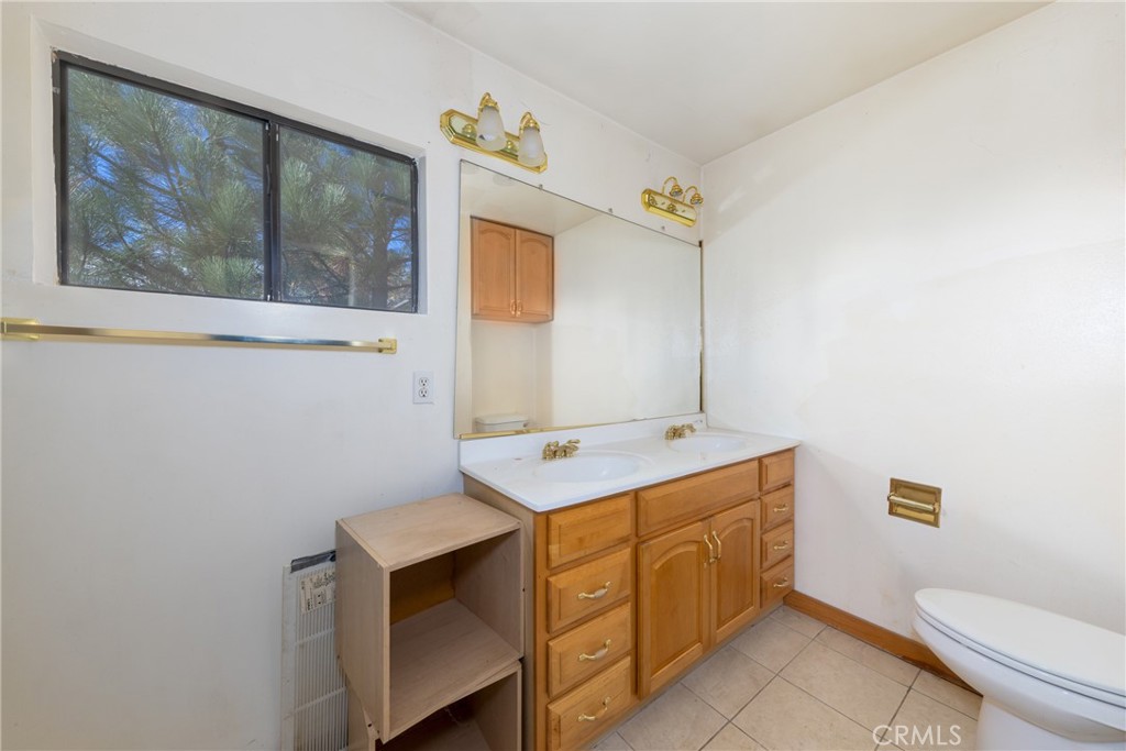 26785 Hopkins Road Idyllwild, CA 92549 - Photo 26 of 46 a bathroom with a sink mirror vanity and toilet