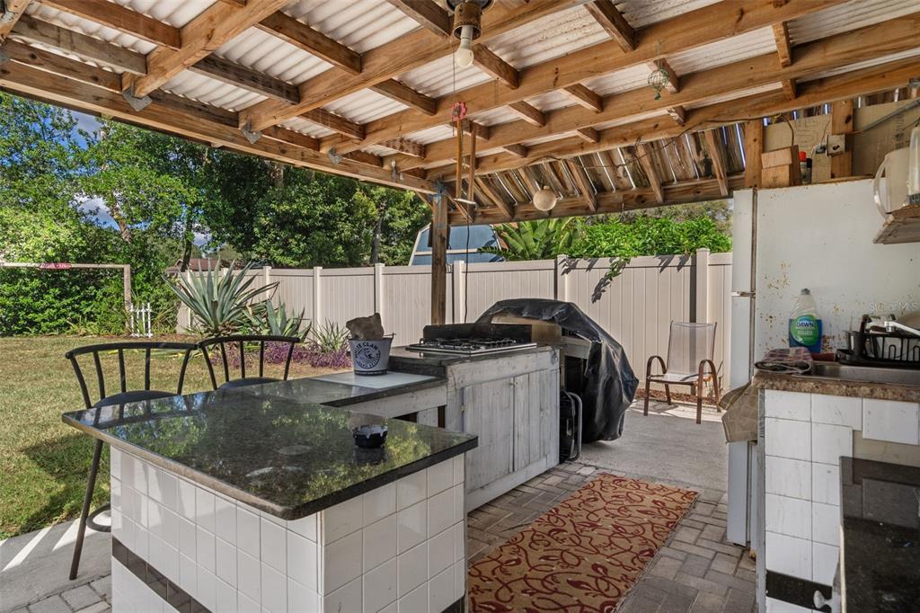 9267 Gibralter Street Spring Hill, FL 34608 - Photo 44 of 50 a kitchen with a stove a sink and a refrigerator