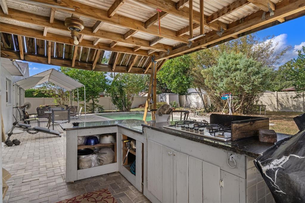 9267 Gibralter Street Spring Hill, FL 34608 - Photo 45 of 50 a open kitchen with stainless steel appliances granite countertop a sink and cabinets