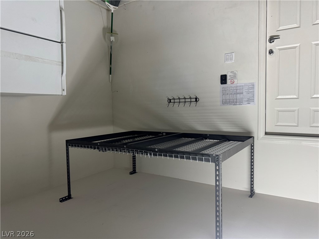 55 Canopus Ridge Way Las Vegas, NV 89183 - Photo 50 of 53 A clean utility area features concrete floors and sturdy shelving ideal for extra storage.