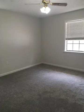 an empty room with a empty space and windows