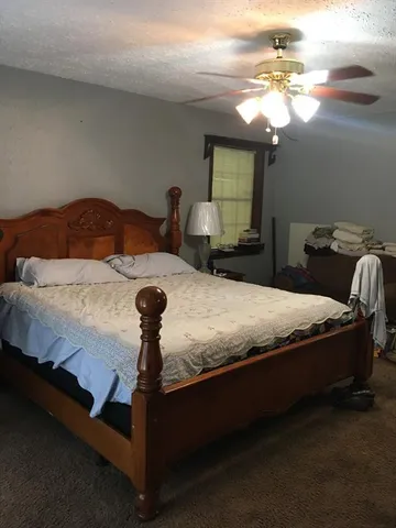 a bedroom with a bed and a chandelier
