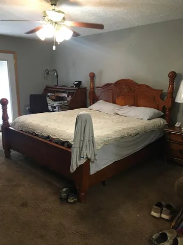 a bedroom with bed and a chandelier
