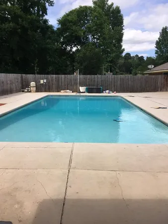 a view of swimming pool with a yard