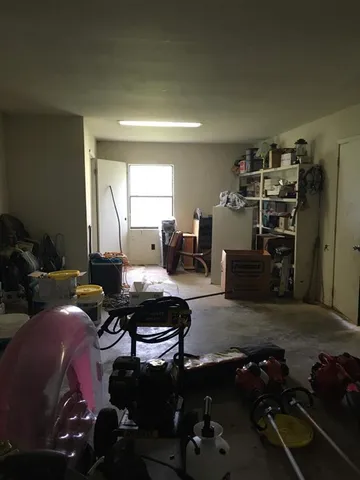 a living room with furniture a wooden floor and a piano