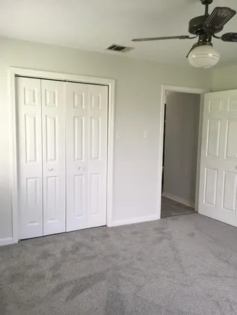 a view of a livingroom with a chandelier fan
