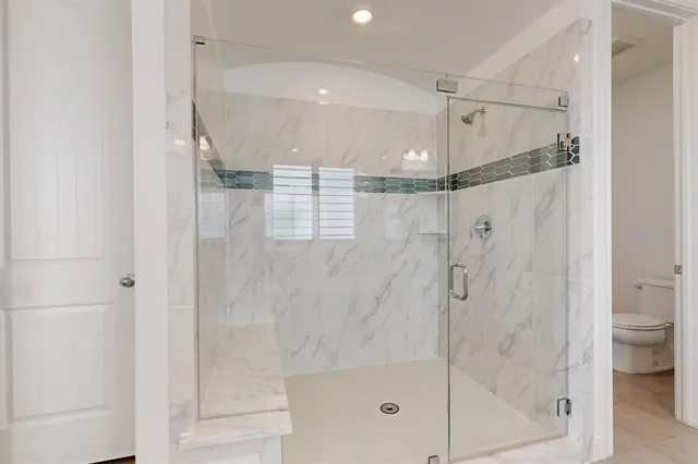 a bathroom with a shower and a sink